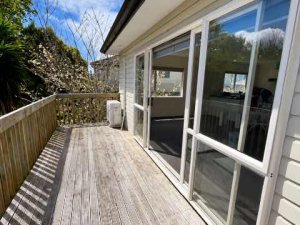 Sunlit Empty Deck with Garden Views
